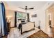 A primary suite with ample natural light showcases hardwood floors, a ceiling fan, and neutral walls at 2246 Sharon Rd, Charlotte, NC 28207
