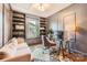 An office includes a comfortable couch, book shelves, and modern desk at 2246 Sharon Rd, Charlotte, NC 28207