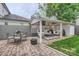 Outdoor patio with seating, a fire pit, and a covered lounge area with white furniture at 2246 Sharon Rd, Charlotte, NC 28207