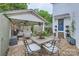 Outdoor patio featuring an outdoor kitchen and dining area, covered seating, and well-maintained landscaping at 2246 Sharon Rd, Charlotte, NC 28207