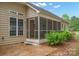 Back screened-in porch with an open door, and mature landscaping at 2646 N Olivers Cross Rd, Newton, NC 28658