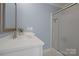 Well lit bathroom with modern fixtures, shower with glass doors, and ample storage at 2646 N Olivers Cross Rd, Newton, NC 28658