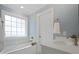 Bright bathroom featuring a tub with tiled surround, white door, and single sink vanity at 2646 N Olivers Cross Rd, Newton, NC 28658