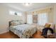 Bright bedroom with neutral decor, wooden floors, and natural light from a large window at 2646 N Olivers Cross Rd, Newton, NC 28658