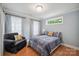 Charming bedroom with hardwood floors, two windows, and a comfortable armchair at 2646 N Olivers Cross Rd, Newton, NC 28658