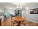 A dining room with hardwood floors adjacent to kitchen and living areas at 2646 N Olivers Cross Rd, Newton, NC 28658