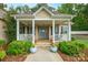 Charming front porch featuring classic columns, a cozy seating area, and a welcoming blue front door at 2646 N Olivers Cross Rd, Newton, NC 28658