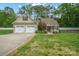 Charming home featuring an attached two-car garage, well-maintained lawn and traditional design elements at 2646 N Olivers Cross Rd, Newton, NC 28658
