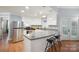 Modern kitchen featuring white cabinets, stainless steel appliances, and a sleek countertop with bar seating at 2646 N Olivers Cross Rd, Newton, NC 28658