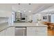 Modern kitchen showcasing white cabinets, stainless appliances, and an open layout connecting to the living spaces at 2646 N Olivers Cross Rd, Newton, NC 28658