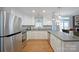 Bright kitchen features white cabinets, stainless steel appliances, and hardwood floors at 2646 N Olivers Cross Rd, Newton, NC 28658
