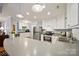 Open concept kitchen with white cabinetry, stainless steel appliances, and a curved breakfast bar for casual dining at 2646 N Olivers Cross Rd, Newton, NC 28658