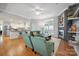 Open concept living room with a modern fireplace, wood floors, and ample natural light at 2646 N Olivers Cross Rd, Newton, NC 28658
