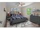 Comfortable bedroom with fun decor, a ceiling fan, dresser, and window overlooking the leafy yard at 2701 Wimbledon Dr, Gastonia, NC 28056
