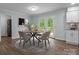 Cozy dining area with doors to the backyard, a round table, pendant lighting, and easy access to the kitchen at 2701 Wimbledon Dr, Gastonia, NC 28056