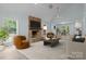 Bright living room with stone fireplace, wood floors, neutral colors, and an open floor plan into the kitchen and dining area at 2701 Wimbledon Dr, Gastonia, NC 28056