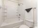 Bright bathroom showcasing a tub with tiled walls and a standard toilet at 3158 Walnut Park Dr, Charlotte, NC 28262