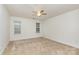 Carpeted bedroom featuring a ceiling fan and two windows for ample light and ventilation at 3158 Walnut Park Dr, Charlotte, NC 28262