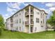 Corner condo unit boasts dual balconies, rear patio, green space, and bright white siding at 3158 Walnut Park Dr, Charlotte, NC 28262