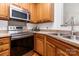 Bright kitchen with stainless steel oven and microwave, and wood cabinets at 3158 Walnut Park Dr, Charlotte, NC 28262