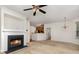 Cozy living room featuring neutral carpet, a fireplace and views into the kitchen at 3158 Walnut Park Dr, Charlotte, NC 28262