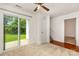 Bright living room featuring neutral carpet, a sliding glass door, and a fan at 3158 Walnut Park Dr, Charlotte, NC 28262