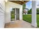 Inviting outdoor patio space with sliding door access and view of the lawn and nearby building at 3158 Walnut Park Dr, Charlotte, NC 28262