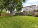 Large backyard with a well-manicured lawn, mature trees, and a storage shed at 335 Greystone Rd, Charlotte, NC 28209