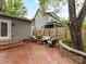 Inviting backyard patio featuring brick pavers, stylish outdoor seating, and a well-maintained fence at 335 Greystone Rd, Charlotte, NC 28209