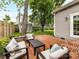 Charming backyard patio with brick pavers, comfortable seating, and lush green landscaping at 335 Greystone Rd, Charlotte, NC 28209