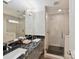 Modern bathroom with double sink vanity, granite countertops, and a glass-enclosed shower at 335 Greystone Rd, Charlotte, NC 28209