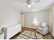Neutral bedroom features a decorative rug, a dresser, and a cozy armchair at 335 Greystone Rd, Charlotte, NC 28209