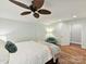 Cozy bedroom with hardwood floors, a ceiling fan, and ample natural light creates a peaceful retreat at 335 Greystone Rd, Charlotte, NC 28209