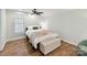 Inviting bedroom features hardwood floors, a ceiling fan, and natural light from the window at 335 Greystone Rd, Charlotte, NC 28209