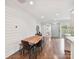 Bright dining room features shiplap walls, wood floors, and flows into the open kitchen at 335 Greystone Rd, Charlotte, NC 28209