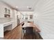 Open dining area with wood floors, shiplap accents, and seamlessly connects to the modern kitchen at 335 Greystone Rd, Charlotte, NC 28209