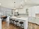 Open kitchen featuring a center island with seating, modern appliances, and hardwood flooring that extends into the dining area at 335 Greystone Rd, Charlotte, NC 28209