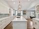 Bright, spacious kitchen with white cabinets, a large island, stainless steel appliances, and hardwood floors at 335 Greystone Rd, Charlotte, NC 28209