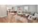 Spacious living room featuring hardwood floors, a sectional sofa, and a view of the kitchen area at 335 Greystone Rd, Charlotte, NC 28209