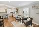 Open-concept living area with hardwood floors, neutral paint, and a view into the modern kitchen with a large island at 335 Greystone Rd, Charlotte, NC 28209