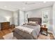 Serene main bedroom with ample lighting, neutral tones, hardwood floors, and a spacious layout at 335 Greystone Rd, Charlotte, NC 28209
