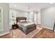 Relaxing bedroom with a tufted headboard, hardwood floors, and calming color palette at 335 Greystone Rd, Charlotte, NC 28209