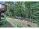 Secluded backyard with mature trees, garden beds, swing, and a deck perfect for relaxation at 4016 Garden Oak Dr, Indian Trail, NC 28079