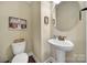 Cozy half-bath features pedestal sink, and classic fixtures at 4016 Garden Oak Dr, Indian Trail, NC 28079
