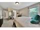 Bedroom featuring neutral walls and carpet, a window with natural light, and a full-length mirror at 4016 Garden Oak Dr, Indian Trail, NC 28079