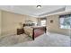 Spacious bedroom with carpet, neutral walls, a window with natural light, and decorative curtains at 4016 Garden Oak Dr, Indian Trail, NC 28079