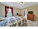 Bedroom featuring a comfortable bed, warm curtains, and direct access to the bathroom at 4016 Garden Oak Dr, Indian Trail, NC 28079