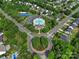 High angle shot showcasing community pool, tennis courts, and landscaped roundabout amidst residential neighborhood at 4016 Garden Oak Dr, Indian Trail, NC 28079