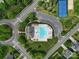 Overhead view of a community pool, clubhouse, and tennis courts surrounded by trees and parking at 4016 Garden Oak Dr, Indian Trail, NC 28079