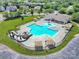 Aerial view of a community pool with slide, shaded seating, and ample lounging space for residents' enjoyment at 4016 Garden Oak Dr, Indian Trail, NC 28079